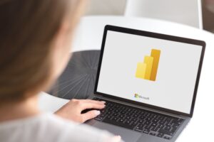 a woman looking at power bi reports examples