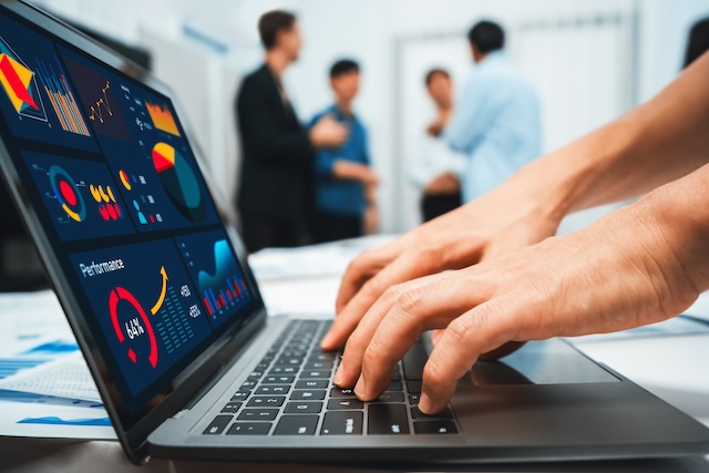 Analyst team uses BI Fintech on a laptop to analyze financial data on blurred background. Business people analyze BI dashboard for insights power into business marketing planning. Prudent